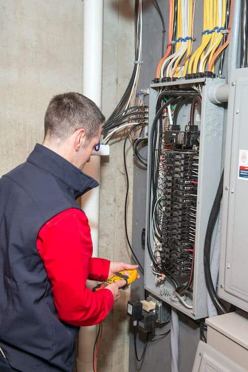 circuit breaker box being worked on by a Heritage Home Service technician