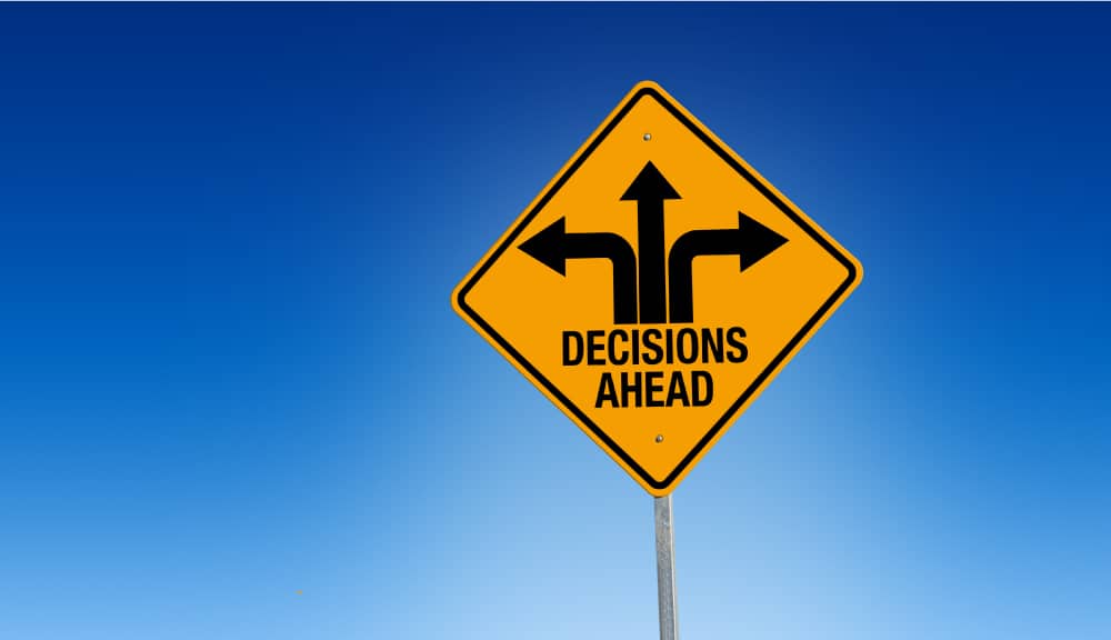 Road sign that says decisions ahead with arrows pointing in three different directions