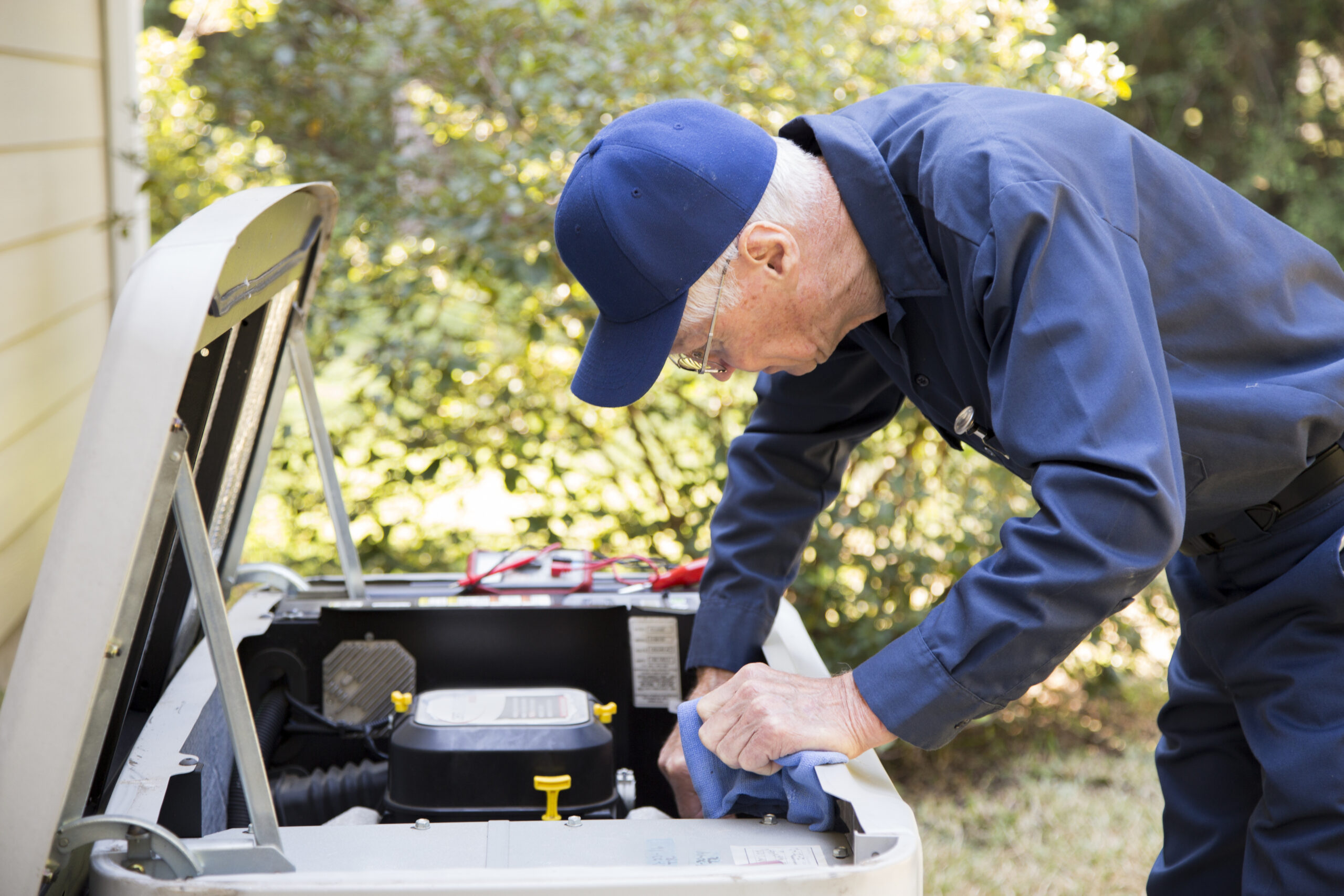 Technician services outside AC units and generator.