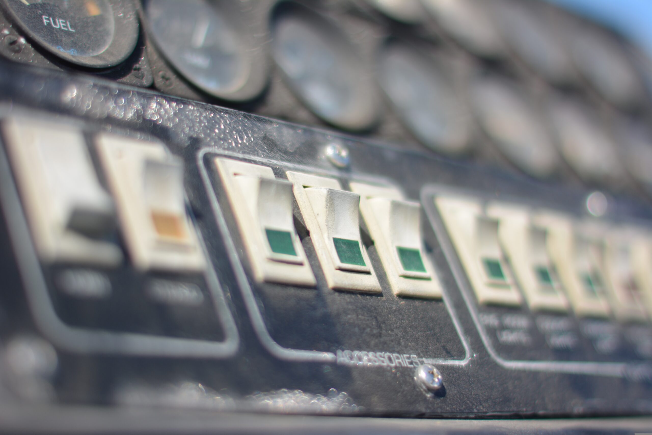 Close-up of a heating system control panel with switches, illustrating troubleshooting during a heating emergency